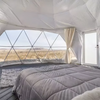 Bedroom inside a geodesic dome with a view of the landscape