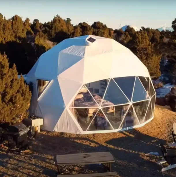 Geodesic dome structure with transparent walls in a natural setting